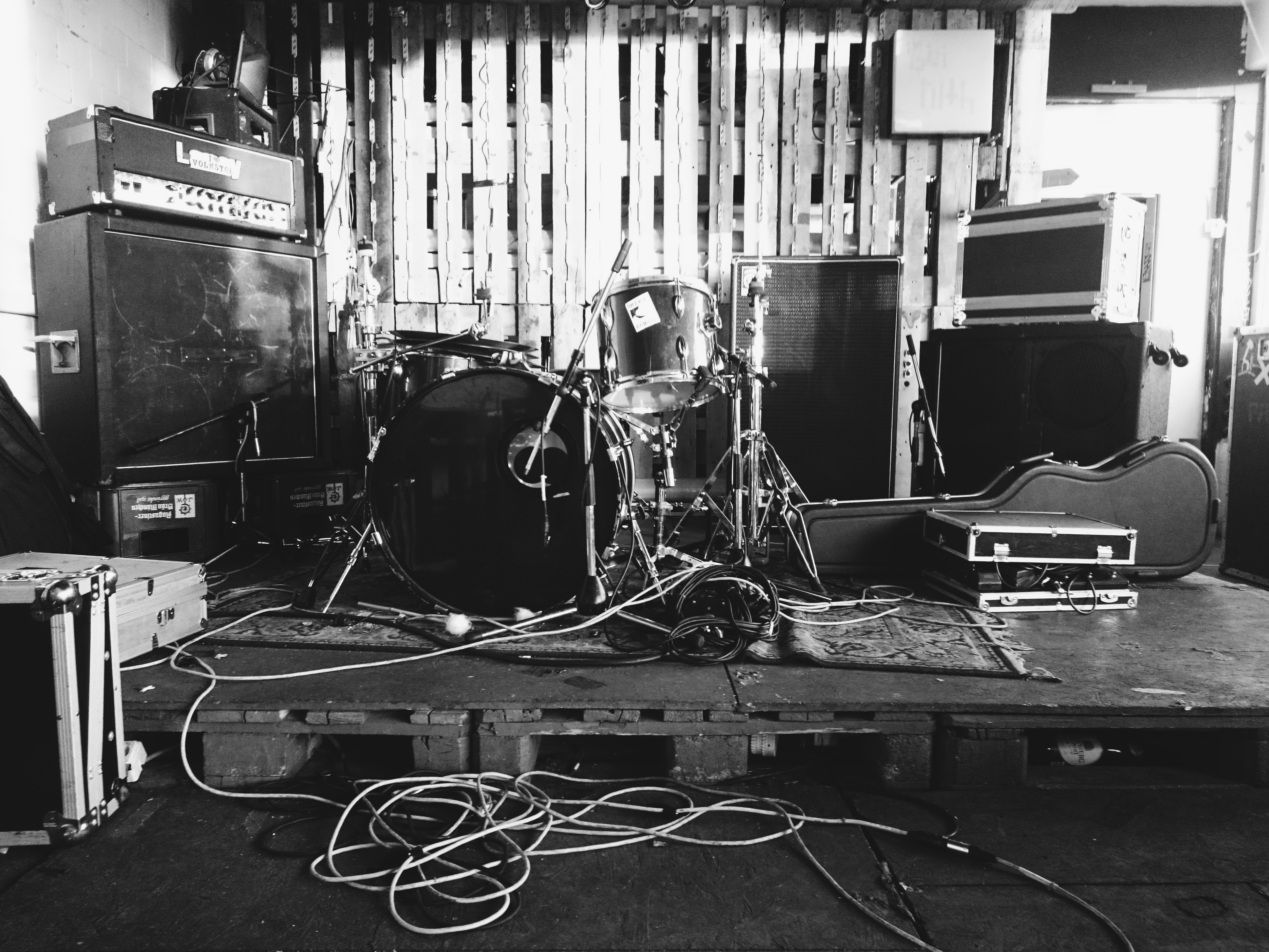 Bei Ruth stage with drum kit, amps and flight cases, black and white